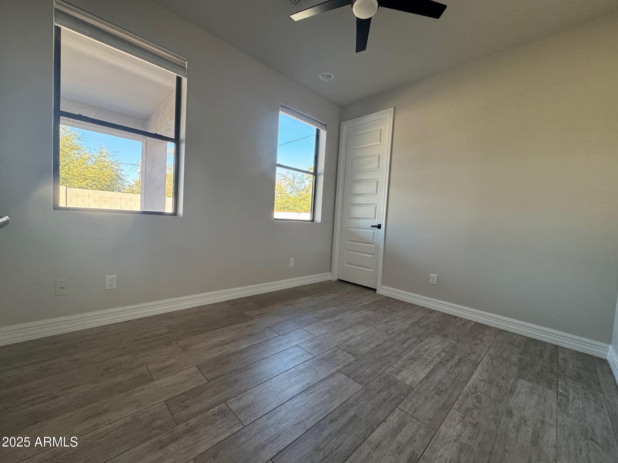 4350 East Kings Avenue Phoenix, AZ 85032 - Photo 14 of 15 wooden floor in an empty room with a window