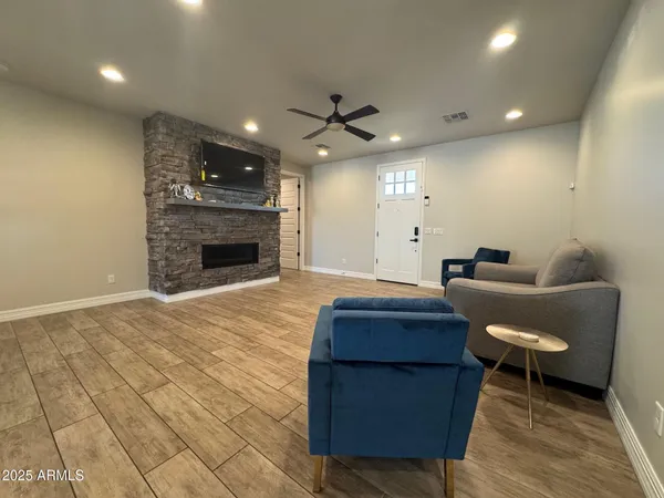a living room with furniture and a fireplace