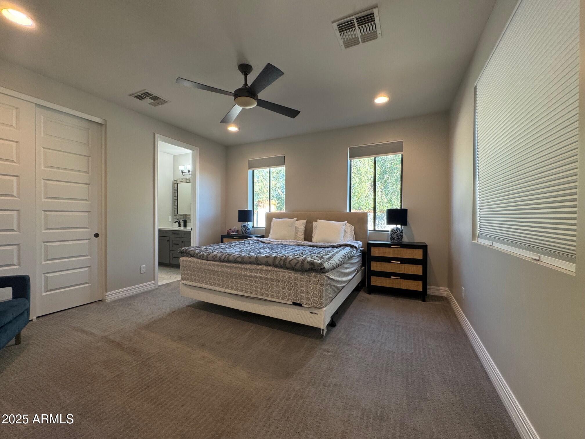 4350 East Kings Avenue Phoenix, AZ 85032 - Photo 7 of 15 a spacious bedroom with a bed and a ceiling fan