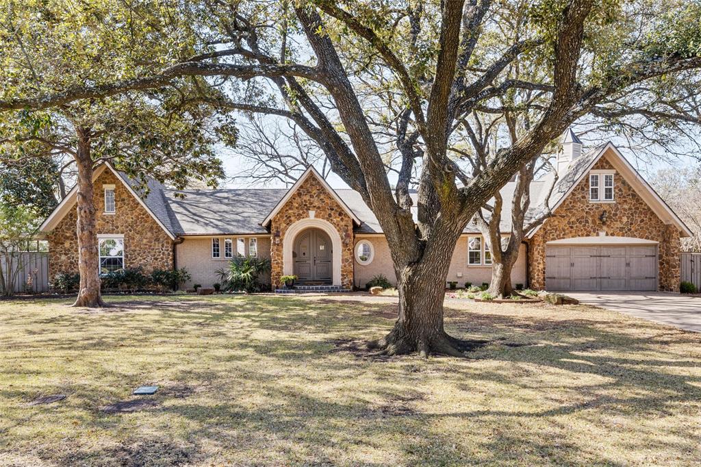 a white house that has a tree in front of it