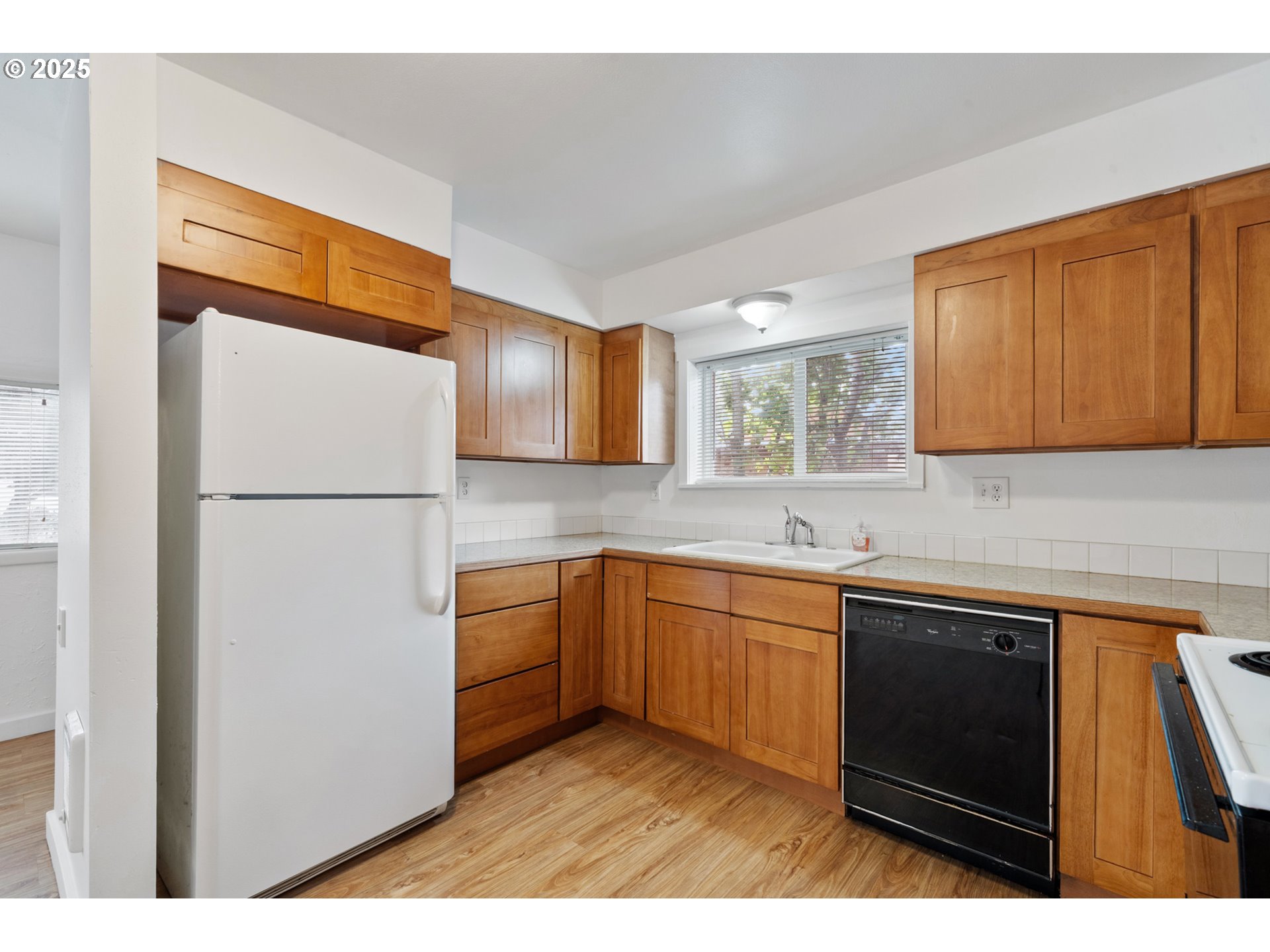 1307 3rd Street Tillamook, OR 97141 - Photo 14 of 42 a kitchen with stainless steel appliances granite countertop a refrigerator a sink dishwasher a stove with wooden floor