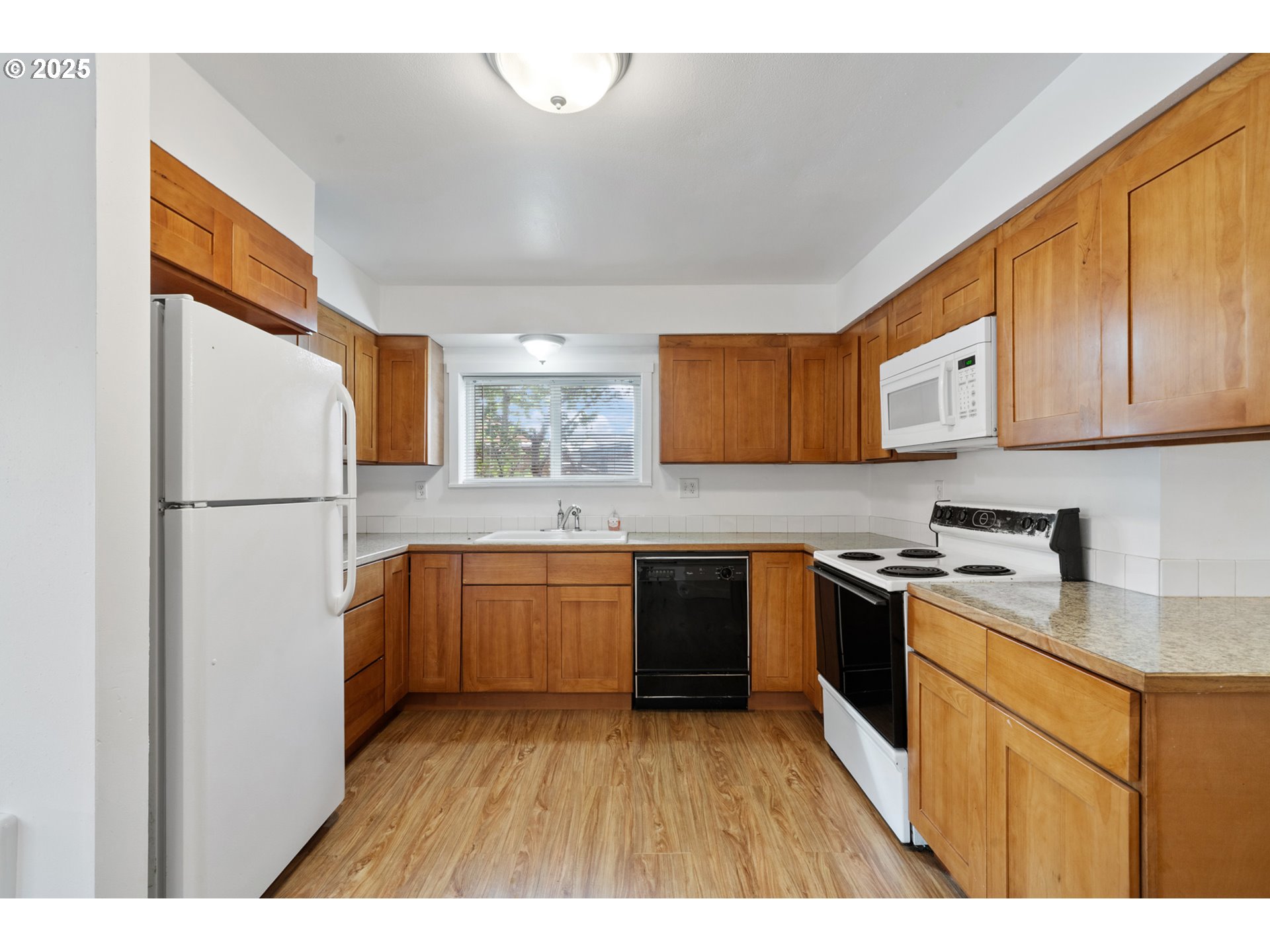 1307 3rd Street Tillamook, OR 97141 - Photo 15 of 42 a kitchen with granite countertop a refrigerator stove top oven and sink