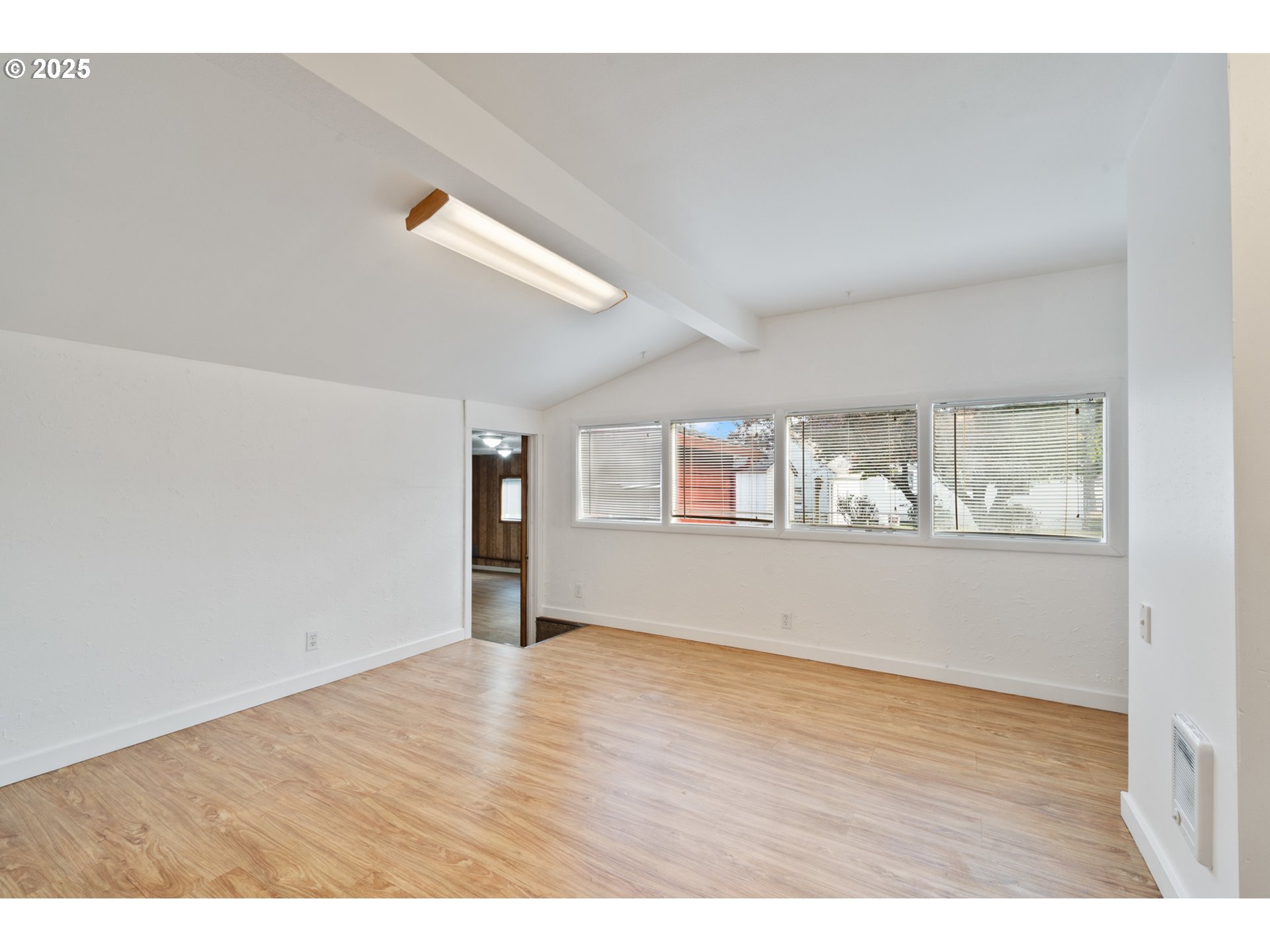 1307 3rd Street Tillamook, OR 97141 - Photo 18 of 42 a view of an empty room with wooden floor and a window