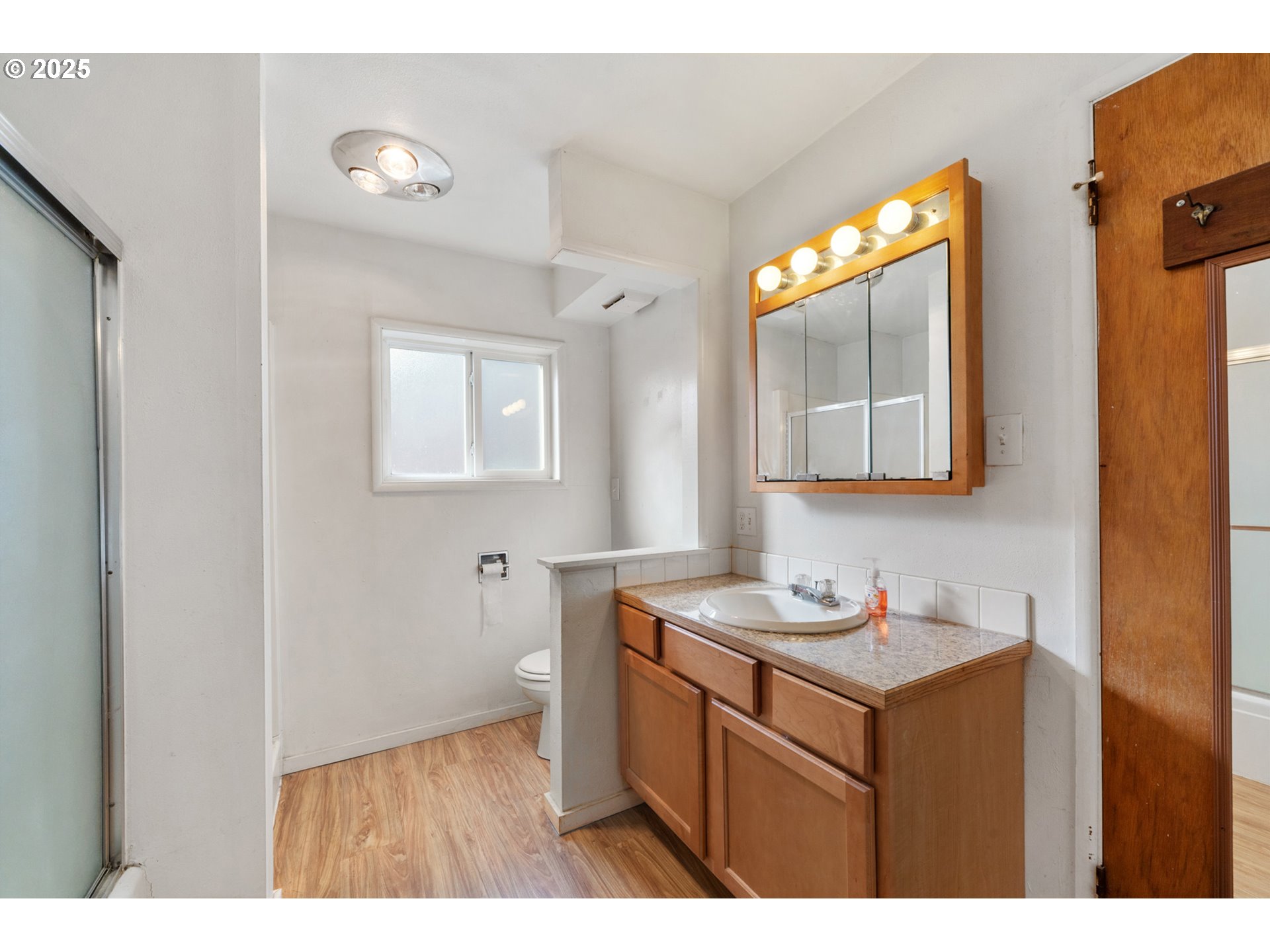 1307 3rd Street Tillamook, OR 97141 - Photo 23 of 42 a bathroom with a sink vanity and mirror