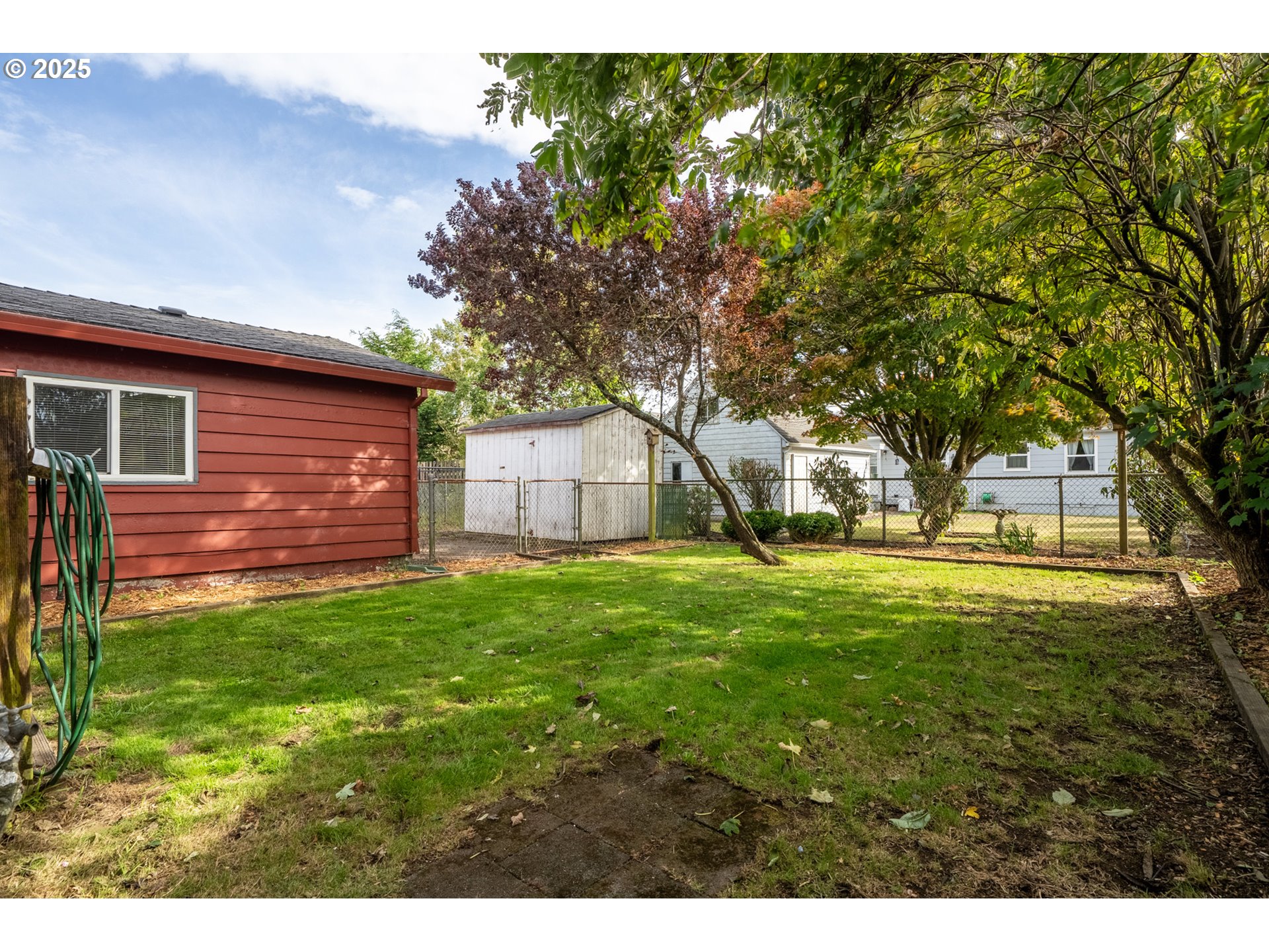 1307 3rd Street Tillamook, OR 97141 - Photo 40 of 42 a view of a backyard with large trees