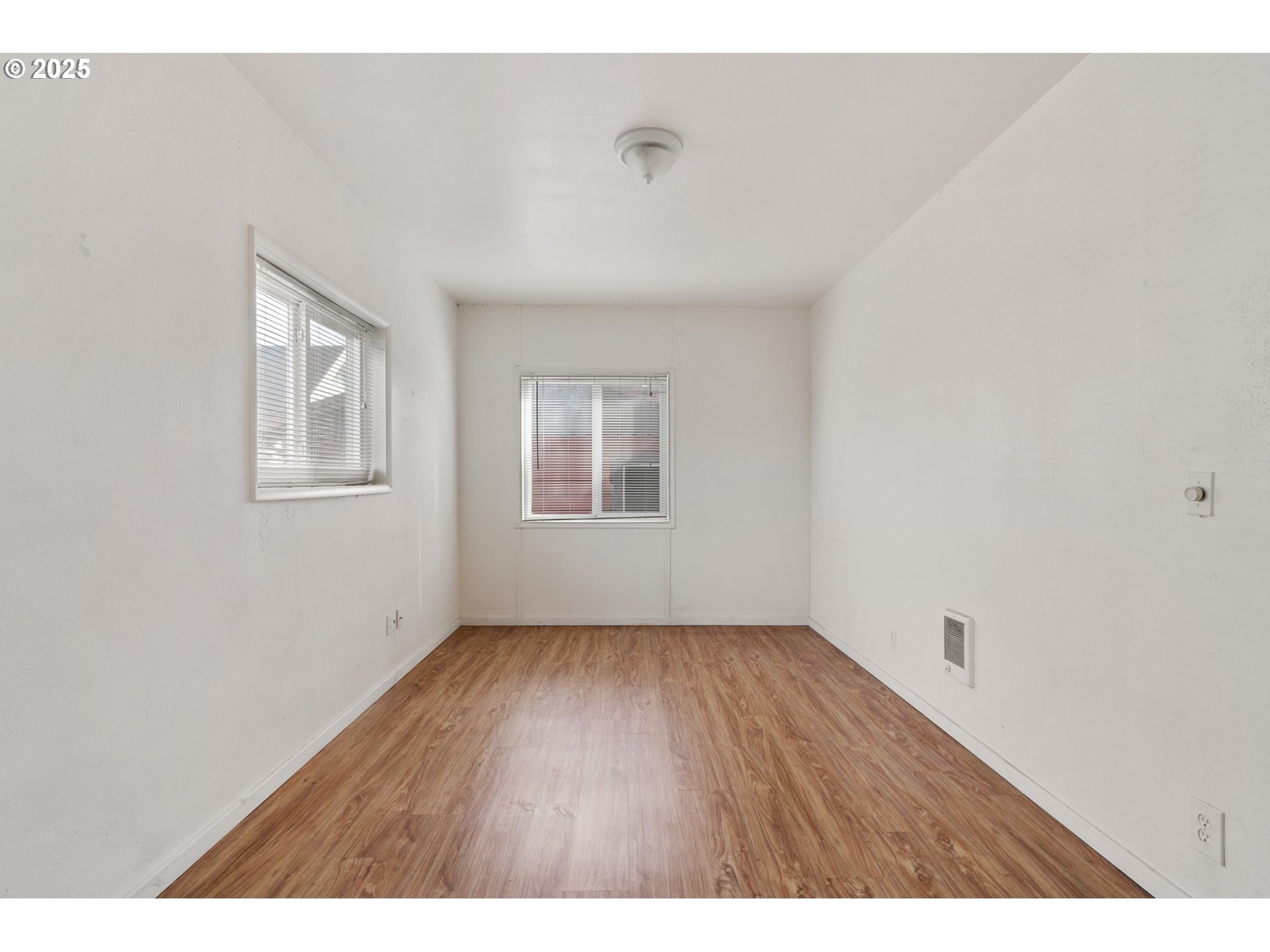1307 3rd Street Tillamook, OR 97141 - Photo 5 of 42 a view of an empty room with wooden floor and a window