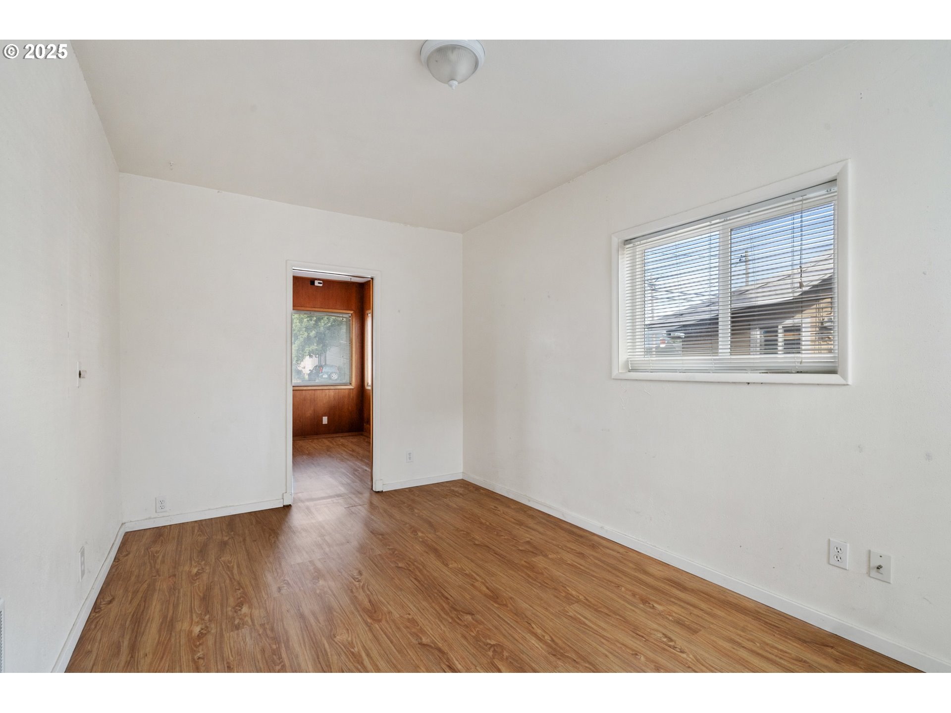 1307 3rd Street Tillamook, OR 97141 - Photo 6 of 42 a view of an empty room with wooden floor and a window