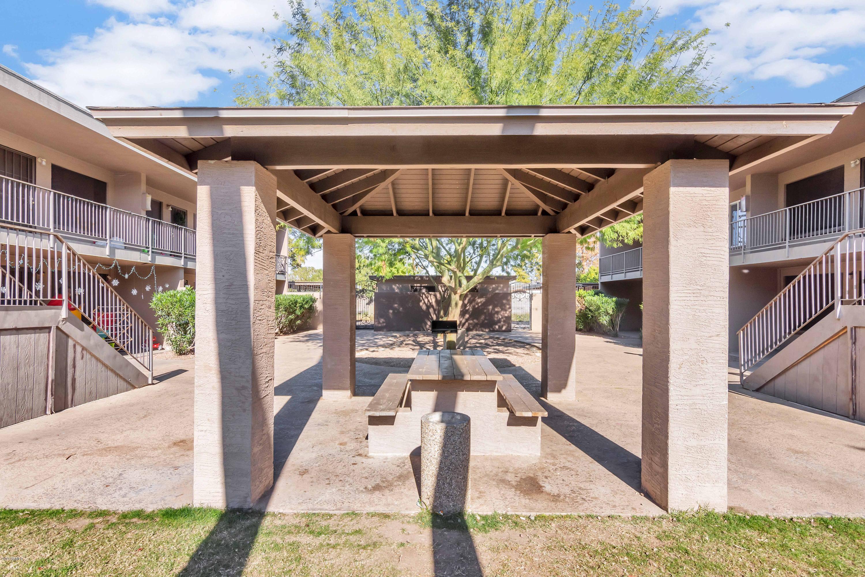1942 West Berridge Lane Phoenix, AZ 85015 - Photo 4 of 13 a view of patio with table and chairs under an umbrella