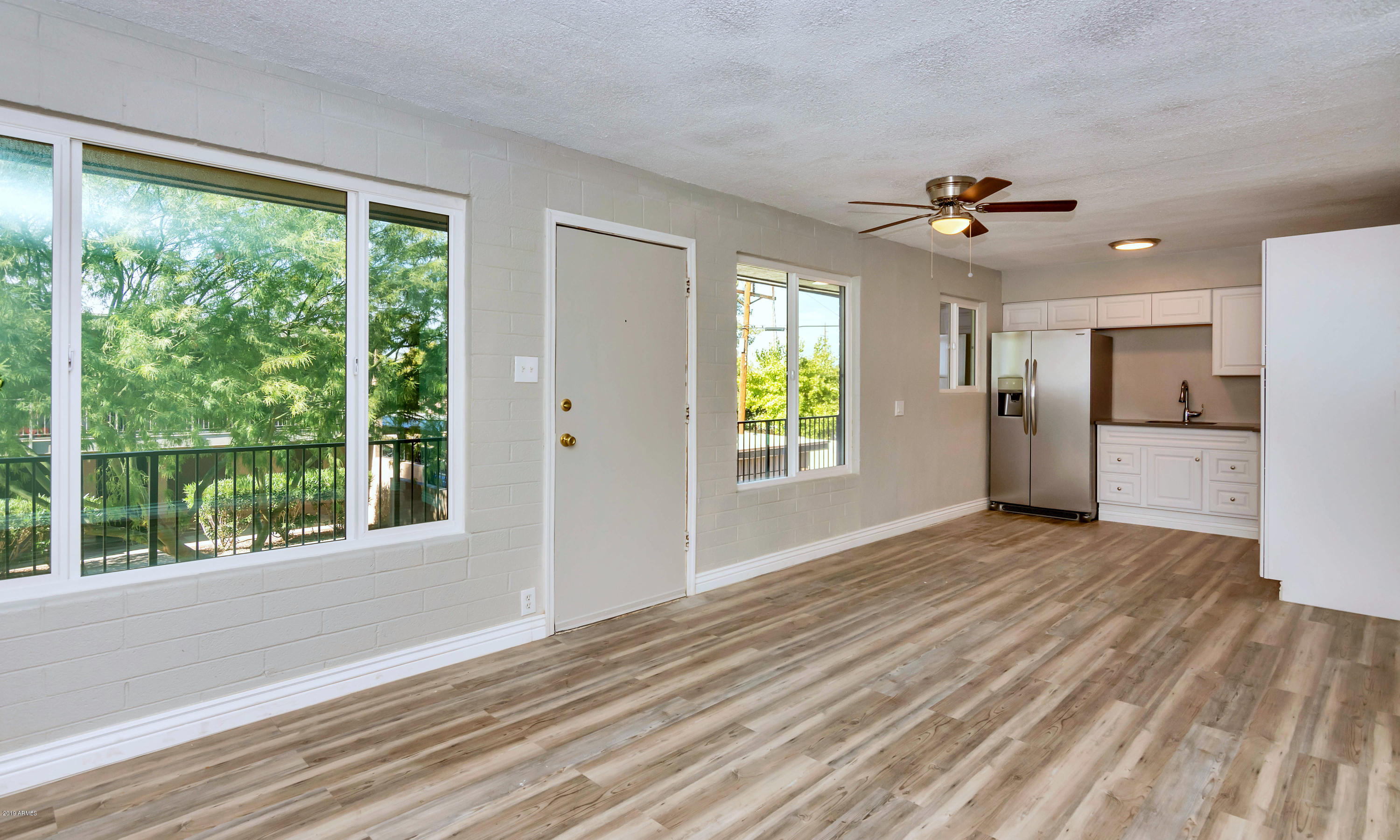 1942 West Berridge Lane Phoenix, AZ 85015 - Photo 5 of 13 a view of empty room with wooden floor and fan