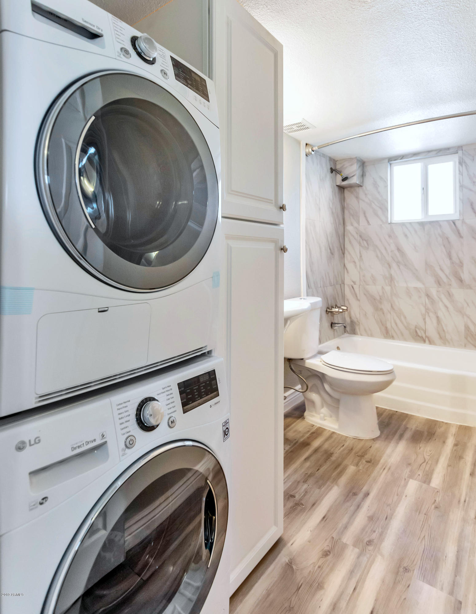 1942 West Berridge Lane Phoenix, AZ 85015 - Photo 7 of 13 a view of a bathroom with washing machine