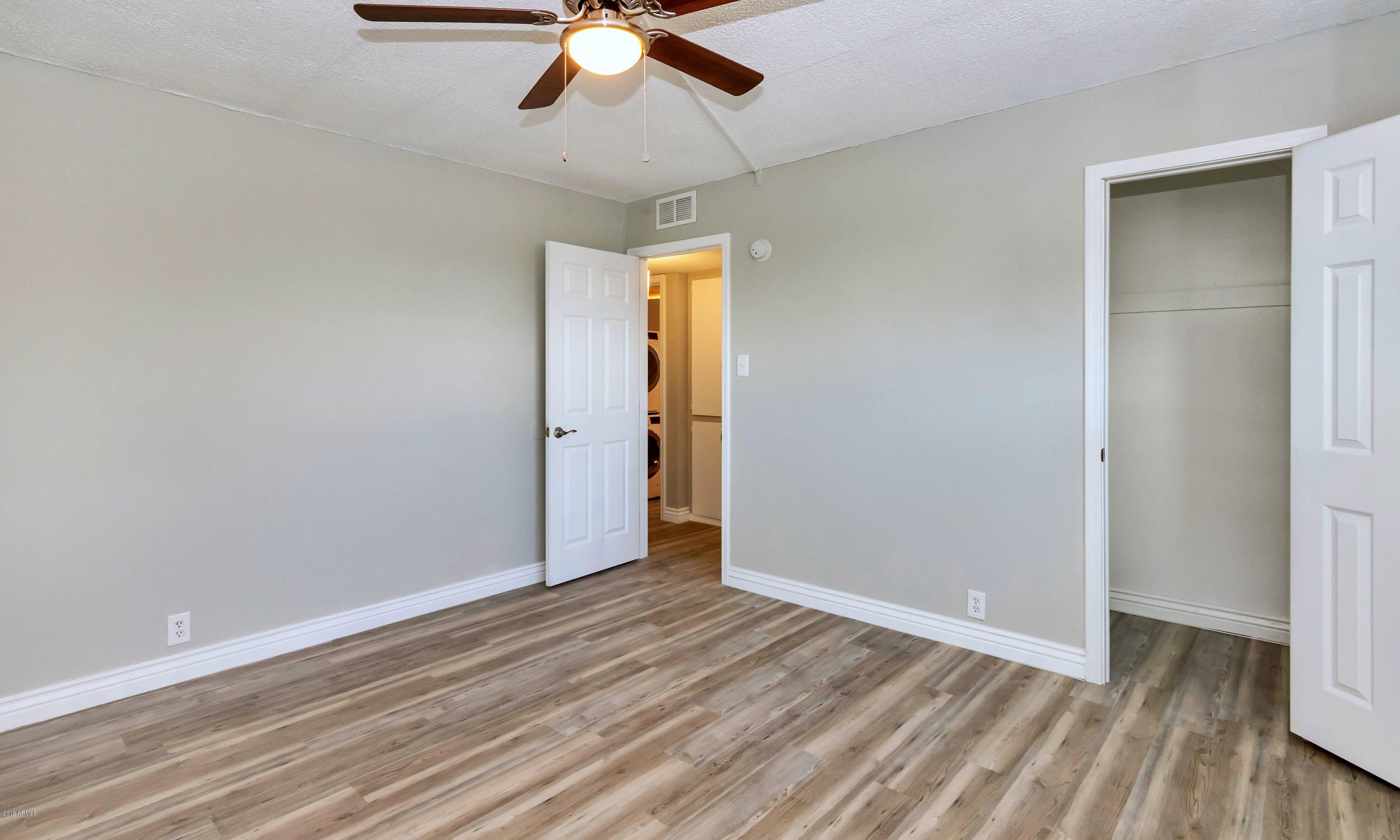1942 West Berridge Lane Phoenix, AZ 85015 - Photo 10 of 13 wooden floor in an empty room with a window