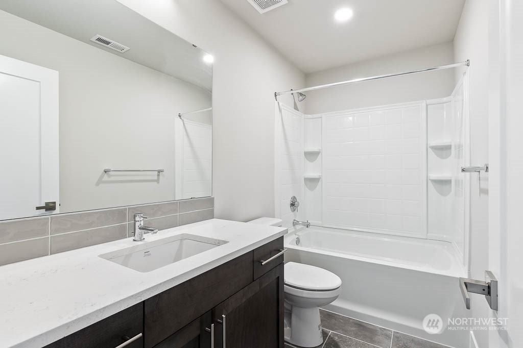 2017 228th Place Southwest, Unit EP 3 Bothell, WA 98021 - Photo 20 of 20 a bathroom with a double vanity sink toilet mirror and shower