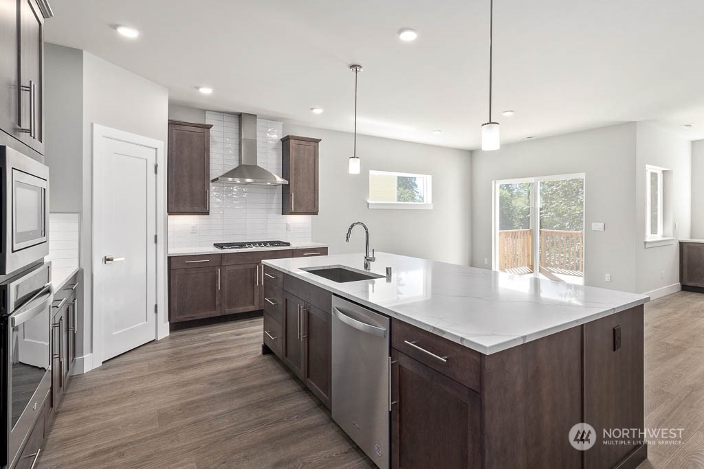 2017 228th Place Southwest, Unit EP 3 Bothell, WA 98021 - Photo 7 of 20 a kitchen with stainless steel appliances granite countertop a sink stove and refrigerator