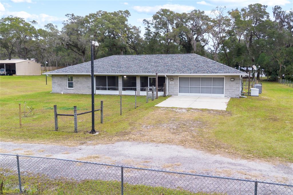 a view of a house with pool and yard