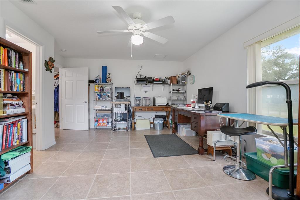 420 Glenwood Road DeLand, FL 32720 - Photo 11 of 36 a living room with furniture and a book shelf