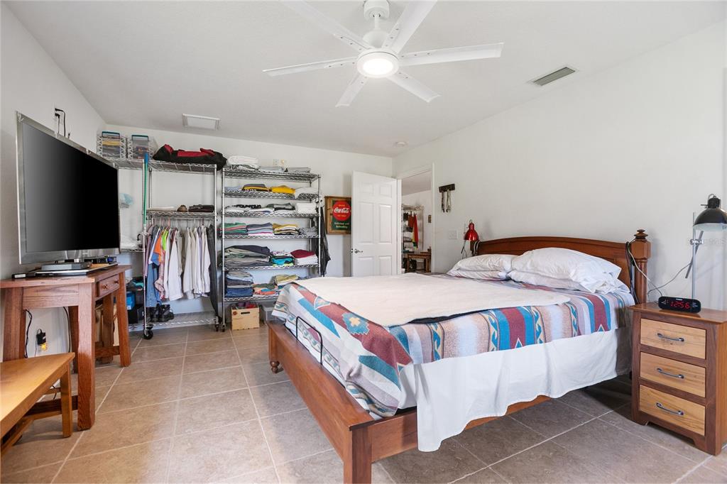 420 Glenwood Road DeLand, FL 32720 - Photo 13 of 36 a bed room with a bed and a flat screen tv