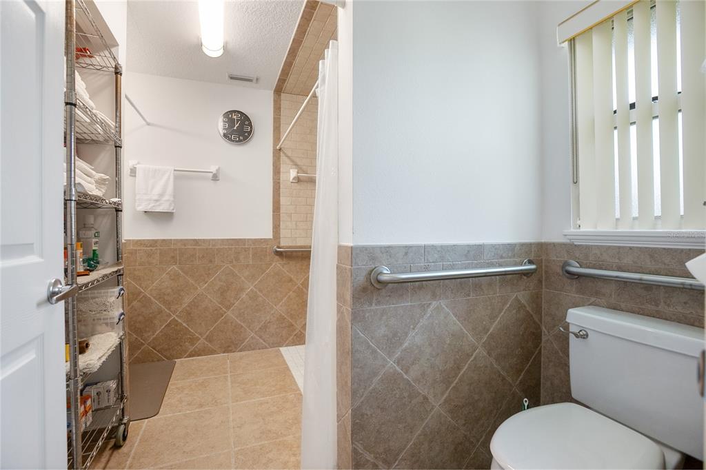 420 Glenwood Road DeLand, FL 32720 - Photo 15 of 36 a bathroom with a toilet and a shower