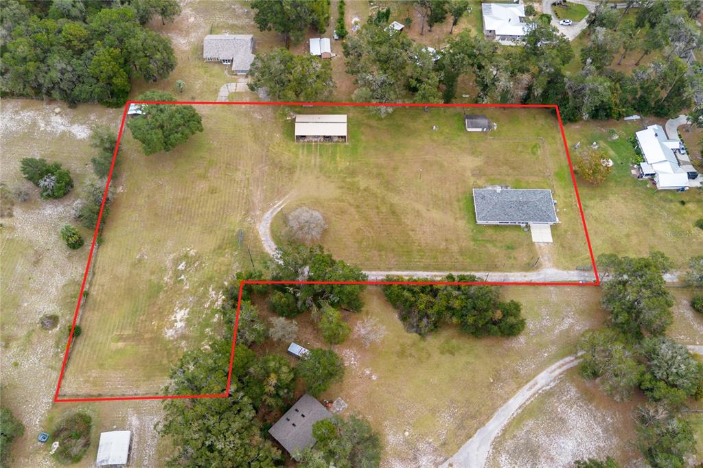 420 Glenwood Road DeLand, FL 32720 - Photo 2 of 36 an aerial view of a house with a yard and lake view