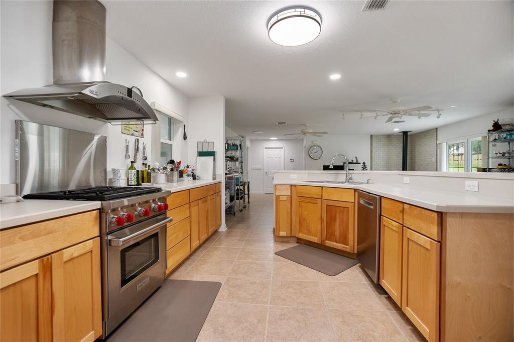 420 Glenwood Road DeLand, FL 32720 - Photo 4 of 36 a kitchen with stainless steel appliances a stove a sink and a refrigerator