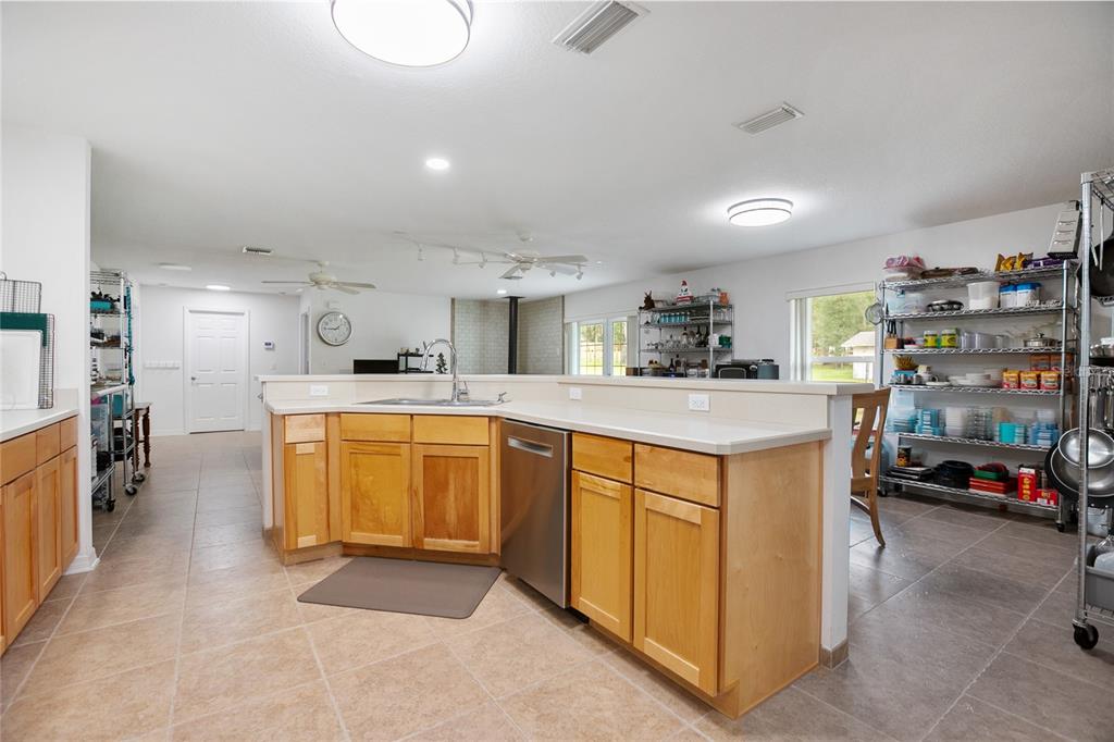 420 Glenwood Road DeLand, FL 32720 - Photo 5 of 36 a kitchen with stainless steel appliances granite countertop a sink and cabinets