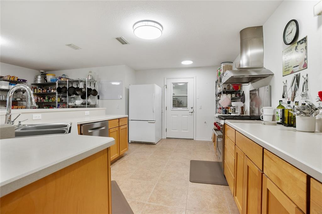420 Glenwood Road DeLand, FL 32720 - Photo 6 of 36 a kitchen with stainless steel appliances granite countertop a sink and cabinets