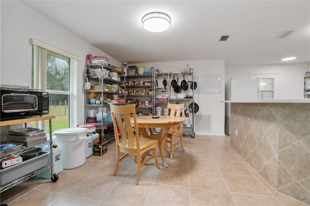 420 Glenwood Road DeLand, FL 32720 - Photo 7 of 36 a view of a dining room with furniture window and outside view