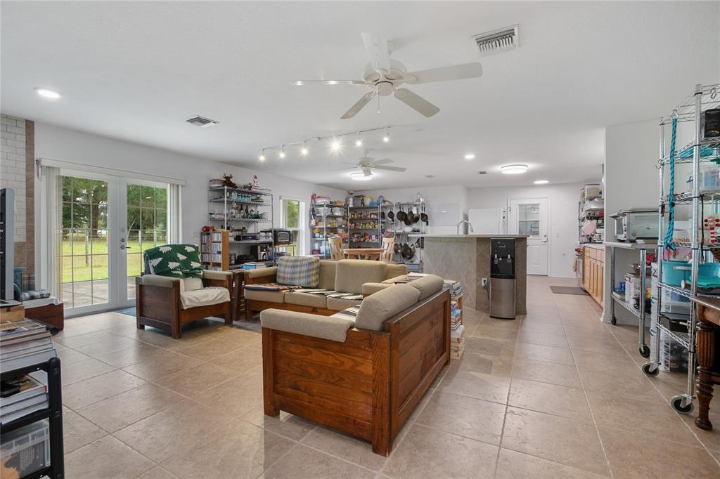 420 Glenwood Road DeLand, FL 32720 - Photo 8 of 36 a living room with furniture kitchen view and a large window