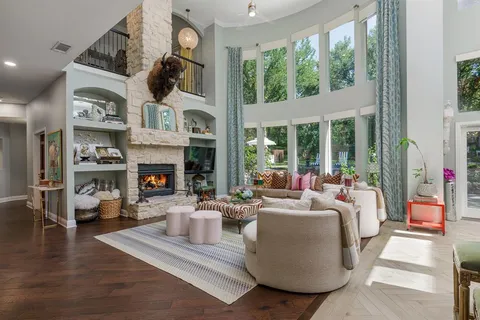a living room with furniture large window and fireplace
