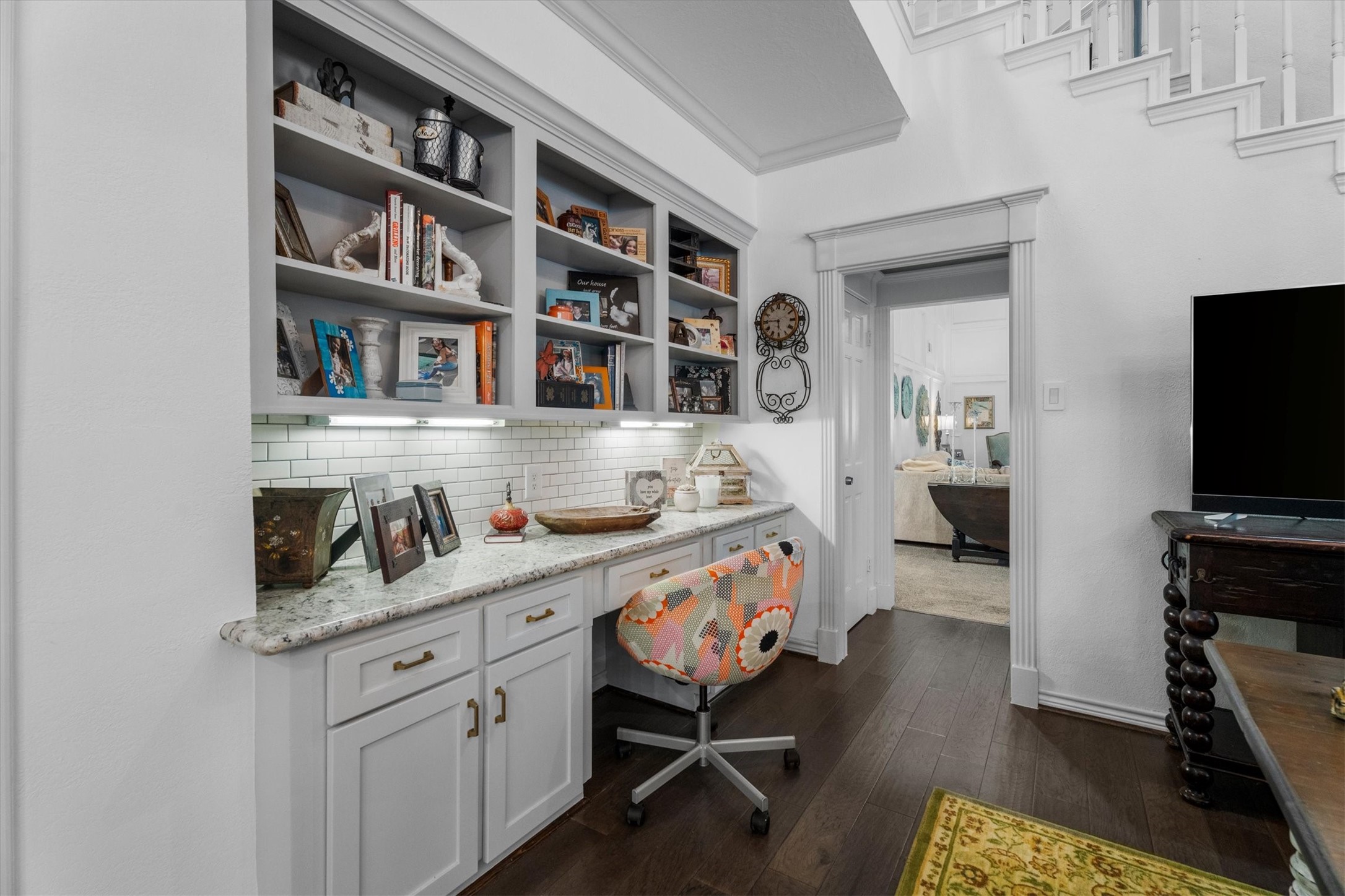 15902 Guinstead Drive Spring, TX 77379 - Photo 11 of 42 Cozy home office nook with built-in shelves and a granite-topped desk. The space includes white cabinetry and under-cabinet lighting.
