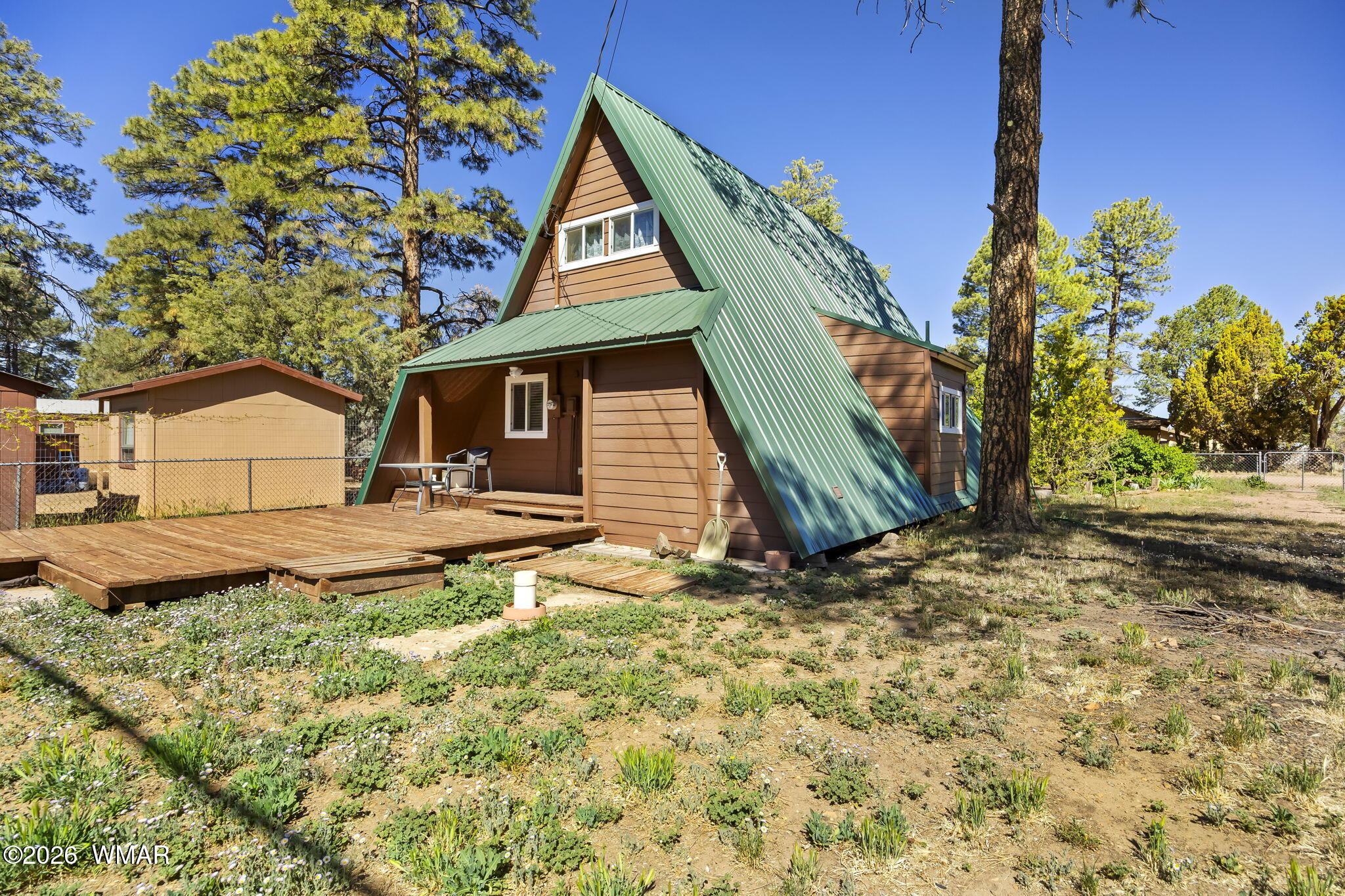 3355 Rim Lakes Drive Overgaard, AZ 85933 - Photo 21 of 37 a view of a house with a yard and wooden fence