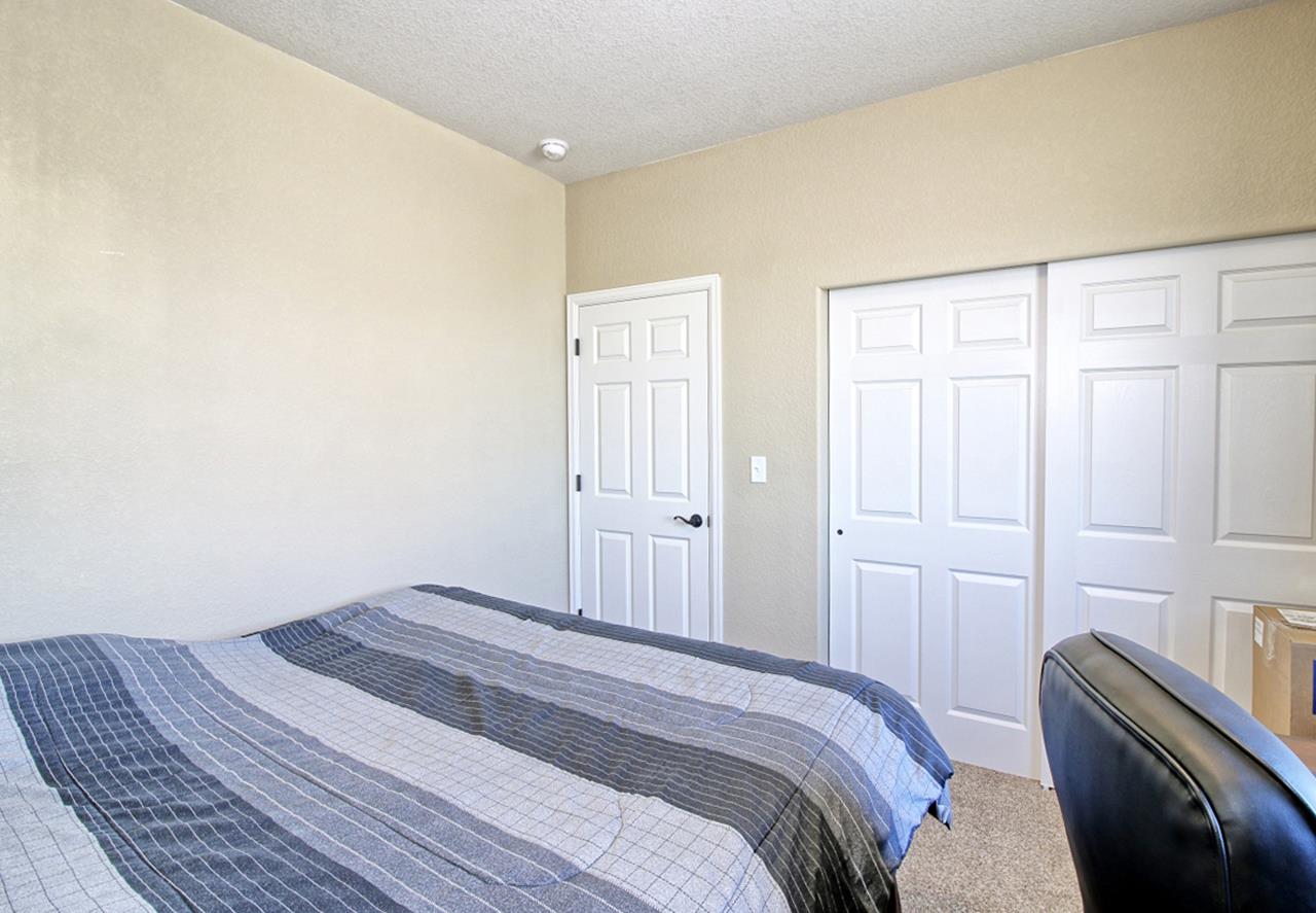 2045 Roma Avenue Fruita, CO 81521 - Photo 15 of 29 a bedroom with a bed and cabinets
