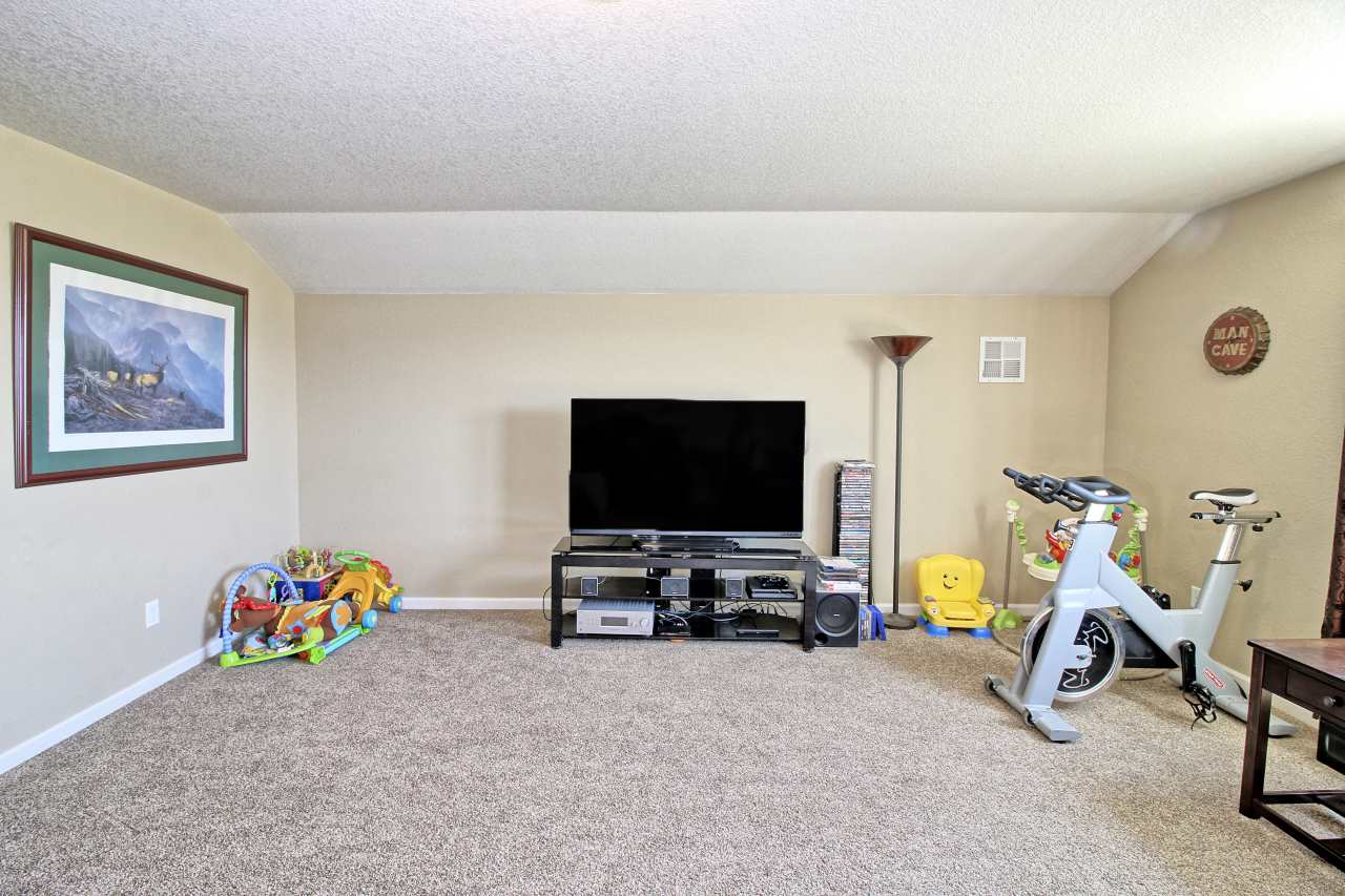 2045 Roma Avenue Fruita, CO 81521 - Photo 18 of 29 a view of a room with toys and a flat screen tv