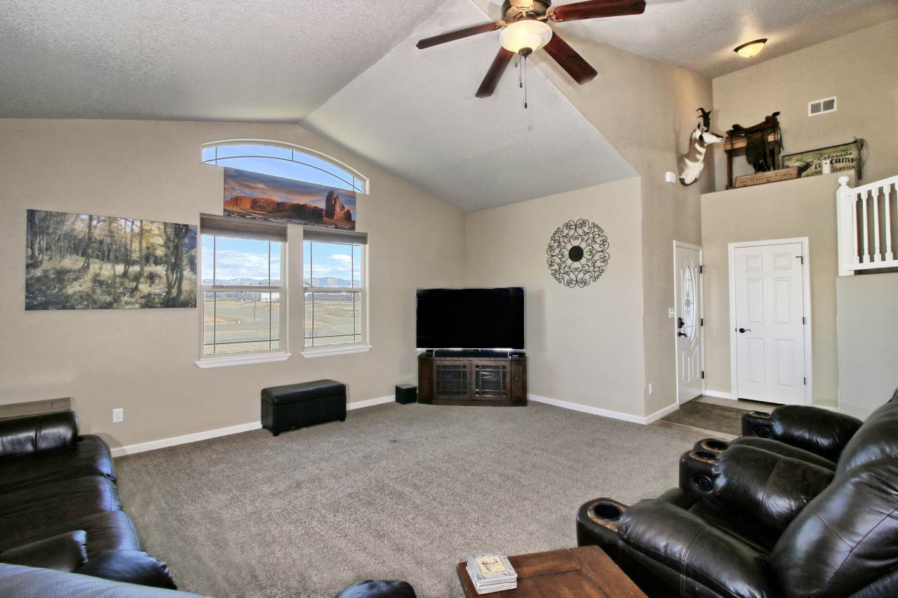 2045 Roma Avenue Fruita, CO 81521 - Photo 2 of 29 a living room with furniture and a flat screen tv