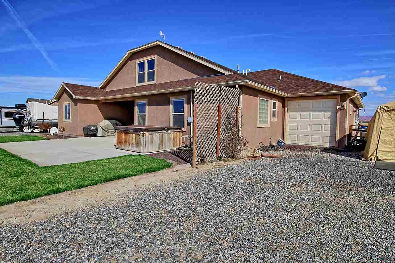 2045 Roma Avenue Fruita, CO 81521 - Photo 25 of 29 a front view of a house with a yard
