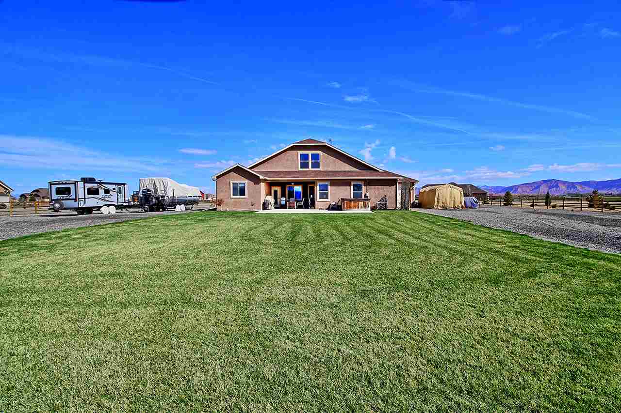 2045 Roma Avenue Fruita, CO 81521 - Photo 26 of 29 a view of a garden with houses in the background