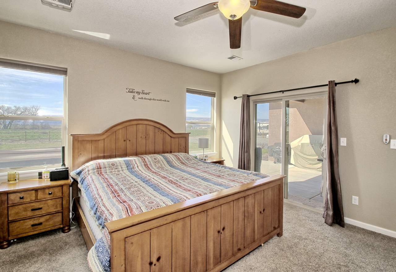 2045 Roma Avenue Fruita, CO 81521 - Photo 9 of 29 a bedroom with a bed and a dresser