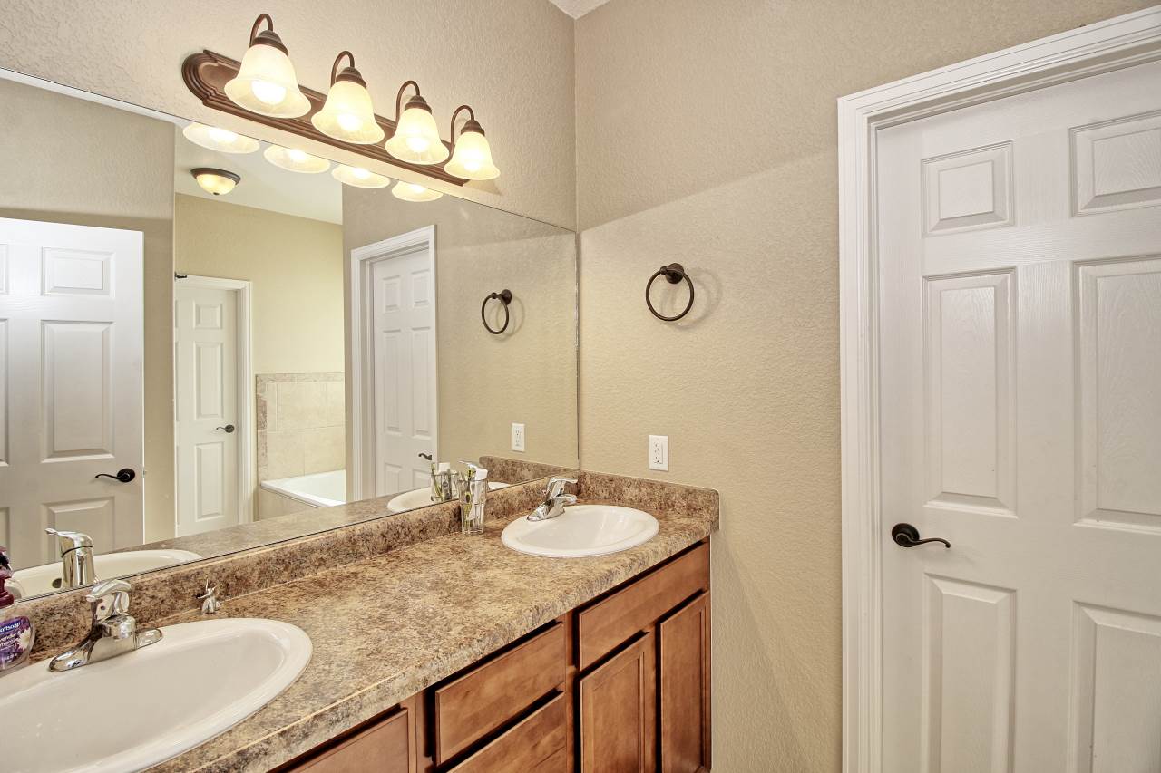 2045 Roma Avenue Fruita, CO 81521 - Photo 10 of 29 a bathroom with a granite countertop sink and a mirror