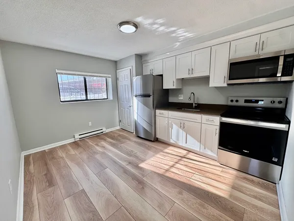 a kitchen with stainless steel appliances granite countertop a stove and a sink