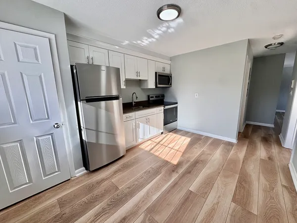 a kitchen with stainless steel appliances a refrigerator and a sink