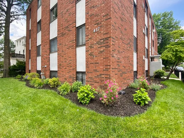 a brick building with a yard