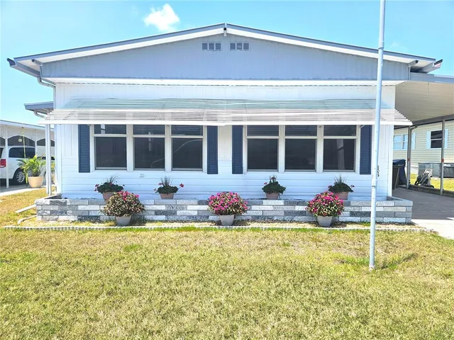 a view of a house with swimming pool and porch