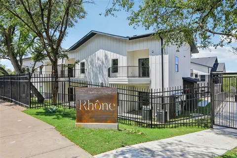 a front view of a house with a garden and swing