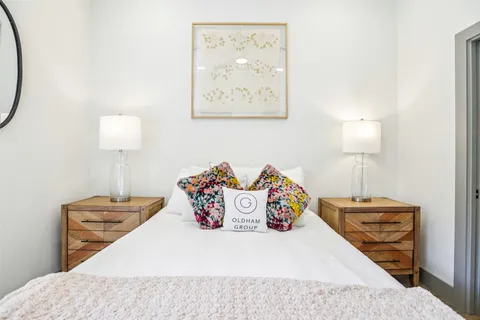 a bedroom with a bed and a lamp on table