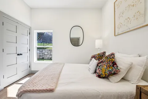 a bed sitting in a bedroom next to a window