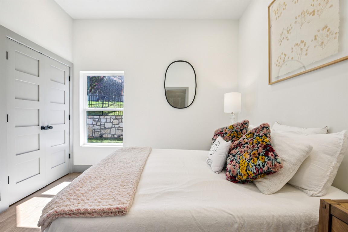 2450 Wickersham Lane, Unit 2011 Austin, TX 78741 - Photo 16 of 31 a bed sitting in a bedroom next to a window