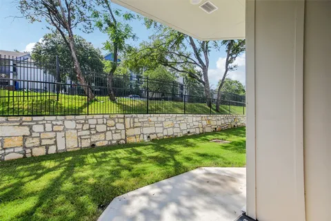 a view of a backyard with table and chairs and potted plants