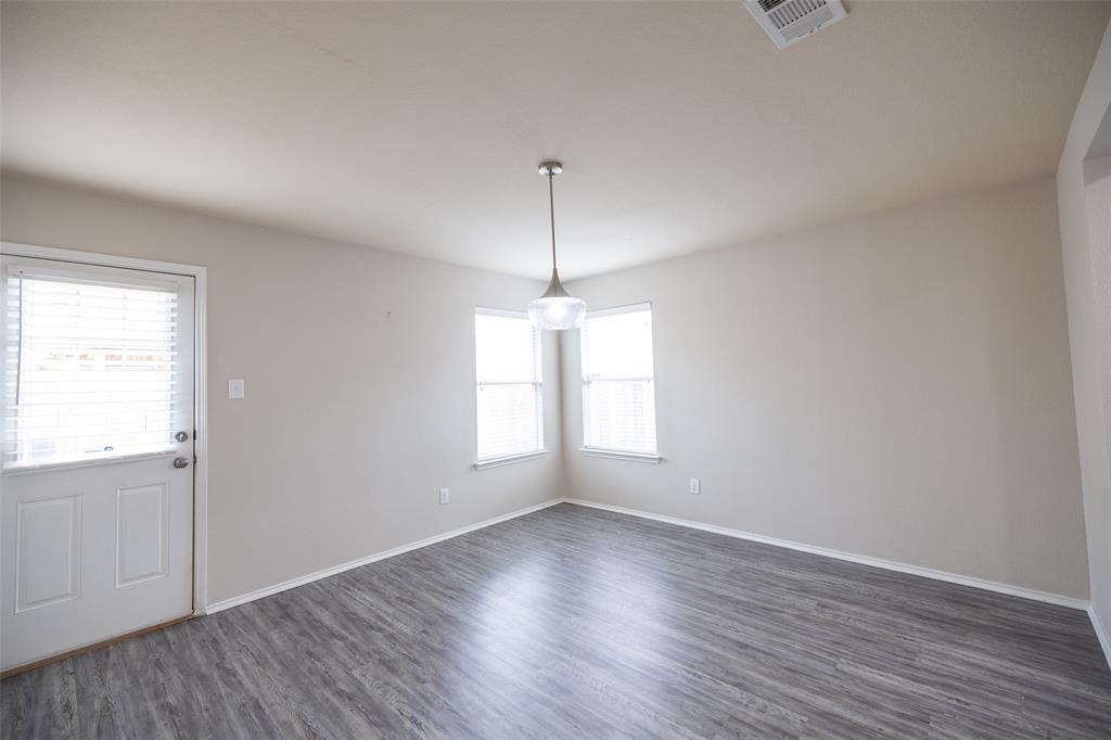 8805 Quarry Ridge Trail Fort Worth, TX 76244 - Photo 11 of 22 an empty room with wooden floor and windows