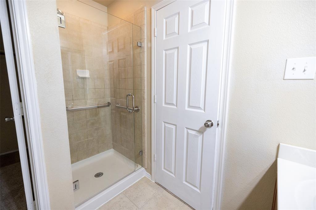 8805 Quarry Ridge Trail Fort Worth, TX 76244 - Photo 15 of 22 a bathroom with a glass shower door