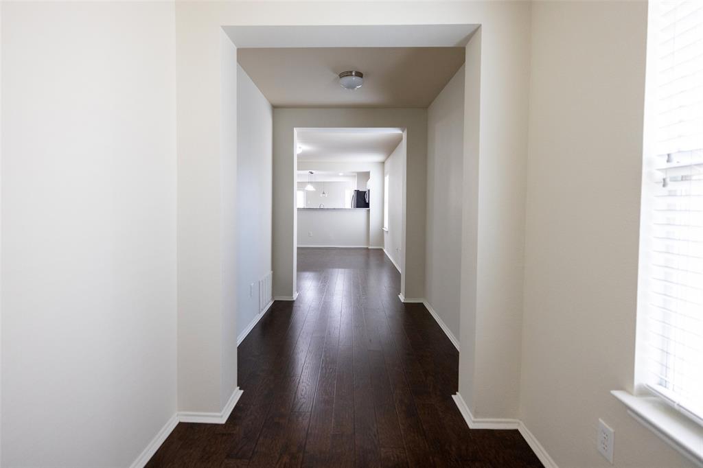 8805 Quarry Ridge Trail Fort Worth, TX 76244 - Photo 3 of 22 a view of a hallway with wooden floor