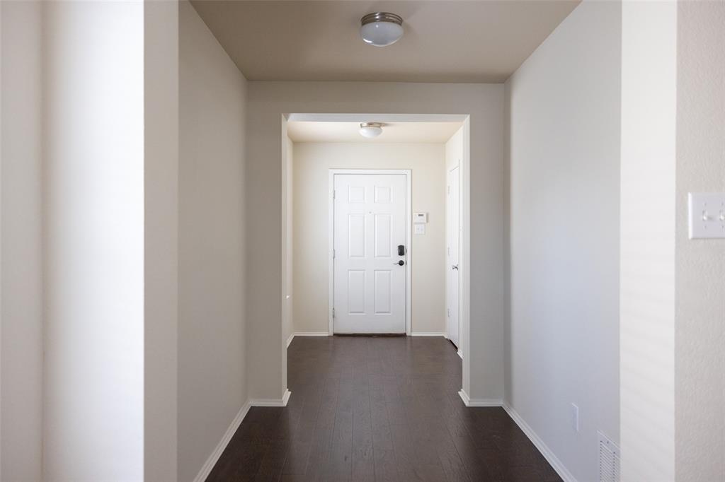 8805 Quarry Ridge Trail Fort Worth, TX 76244 - Photo 4 of 22 a view of a hallway with wooden floor